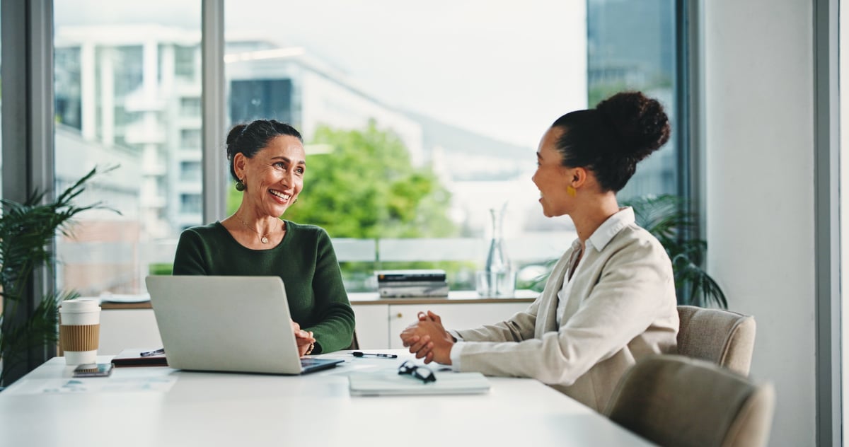 Consultants reviewing performance in a meeting